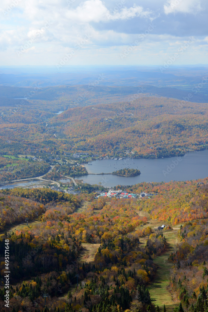 Aerial view of Lake Tremblant and Mont-Tremblant village in fall with fall foliage, from top of Mont Tremblant, Quebec QC, Canada.