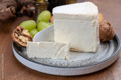Delice de Bourgogne French cow's milk cheese from Burgundy region of France served with grapes, wine and walnuts
