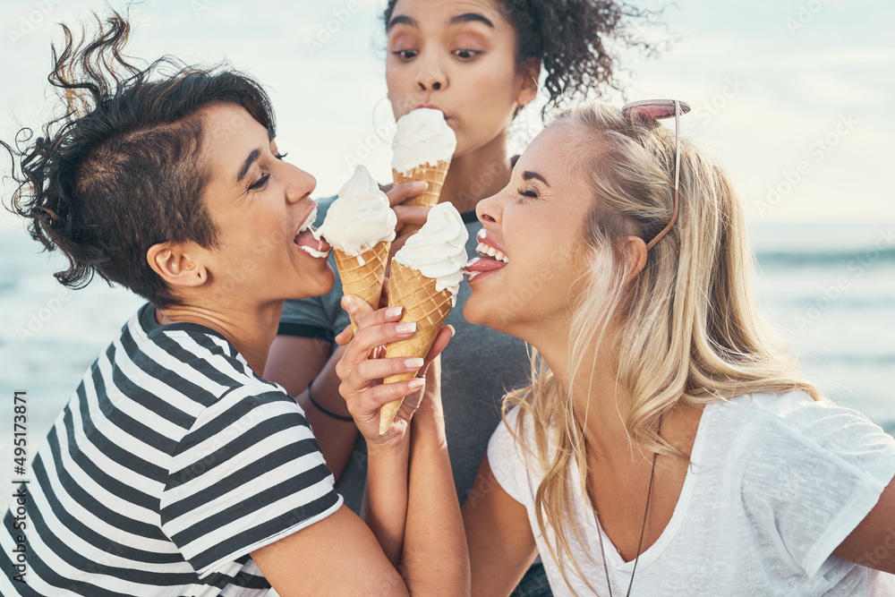 Ice cream makes the girls go wild. Cropped shot of three friends eating ice while out on the promenade. Ice cream makes the girls go wild. Cropped shot of three friends eating ice while out on the promenade.