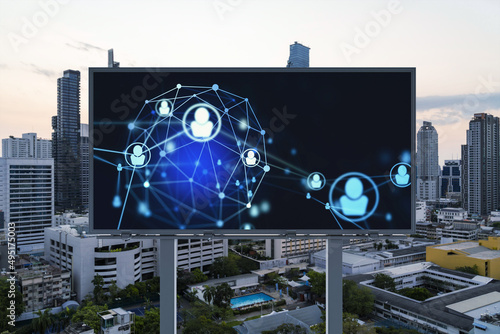 Glowing Social media icons on billboard over sunset panoramic city view of Bangkok. The concept of networking and establishing new connections between people and businesses in Southeast Asia photo