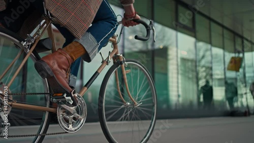 Midsection Close up leg shot of a businessman with bicycle commuting to the office. Modern building. Copyspace