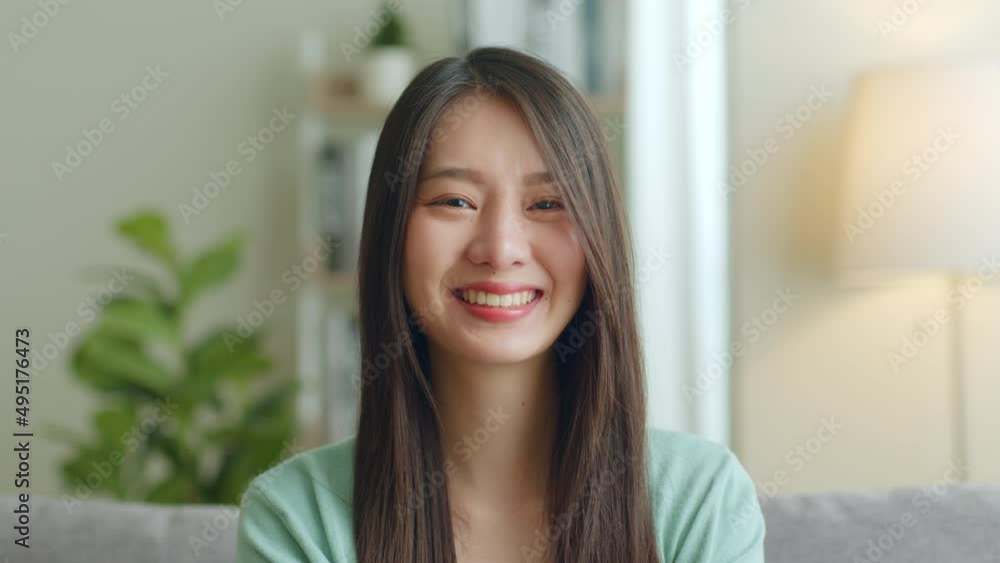 Portrait of young Asian woman look at camera and smile at home. Portrait of young Asian woman look at camera and smile at home.