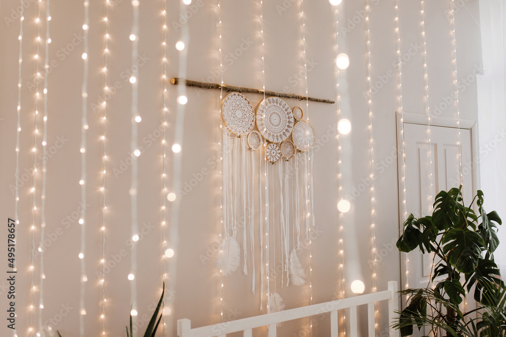 Dreamcatcher in the New Year's interior above the bed with garlands Dreamcatcher in the New Year's interior above the bed with garlands