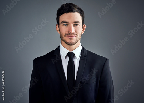 I succeed. Thats what I do. Studio portrait of a handsome young businessman dressed in a suit against a grey background.