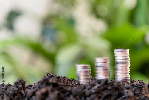 pile of silver coins with green nature background. money saving and business finance concept, business growth and money future, financial success