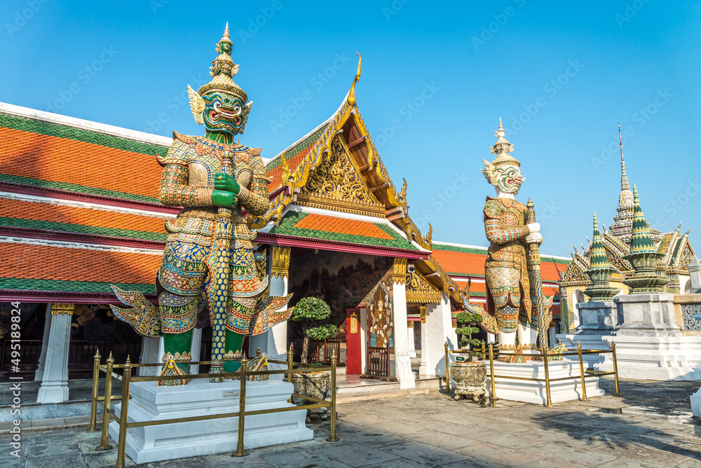 The two giant statue in Wat Pra Kaew, The Grand Palace, blue sky, landmark Thailand. Travel in Asia concept.