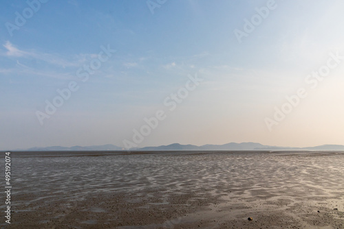 blue sky and waterless mudflats