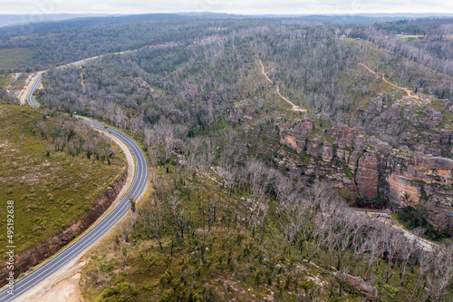 Drone aerial photograph of a highway running through a forest in regional Australia.