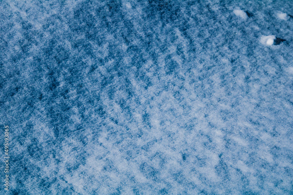 A closeup photo of a snow-covered yard for texture in Orwell, Ohio