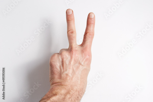 Hand on a white background two fingers index and middle point up © Oleg