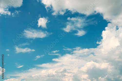 Blue sky, white clouds with yellow spots