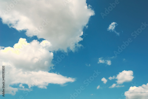 Blue sky  white clouds with yellow spots