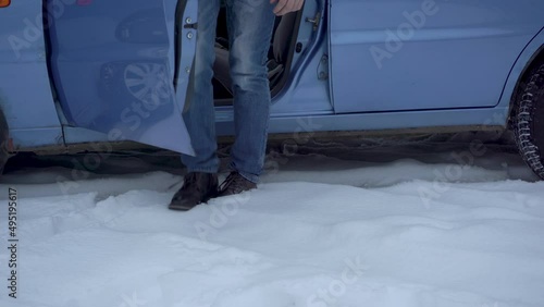 get out of the car in the snow,the driver got out of the car in the winter