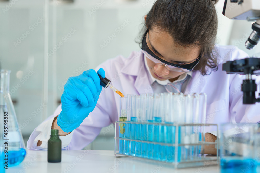 Laboratory research concept, Scientist working in lab to drop of solution into tube for research Laboratory research concept, Scientist working in lab to drop of solution into tube for research