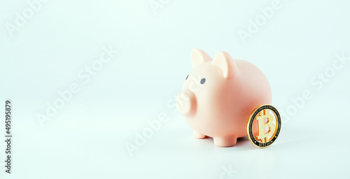 Save currency bitcoin. Pink pig bank with golden bit coin money BTC on white background. Save money investment and business finance.