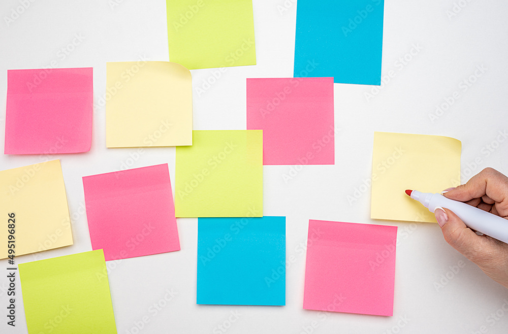 Mockup sticky Note Paper. hand with red marker ready to write. Business people meeting and use post it notes to share idea on sticky note. Discussing business, teamwork, brainstorming concept Mockup sticky Note Paper. hand with red marker ready to write. Business people meeting and use post it notes to share idea on sticky note. Discussing business, teamwork, brainstorming concept