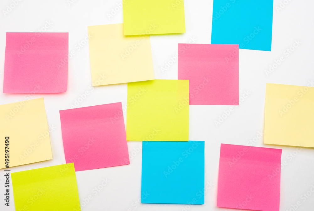 Fototapeta premium Mockup sticky Note Paper. Many colored empty sticker notes on white wall. blank Sticker notes on white background. empty sheets for notes on bulletin board