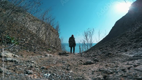 A man goes to the sea with rocks. GoPro. 4k