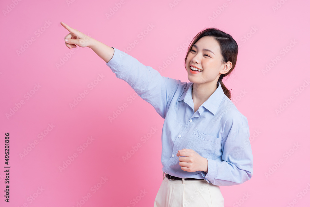 Image of young beautiful Asian girl posing on pink background Image of young beautiful Asian girl posing on pink background
