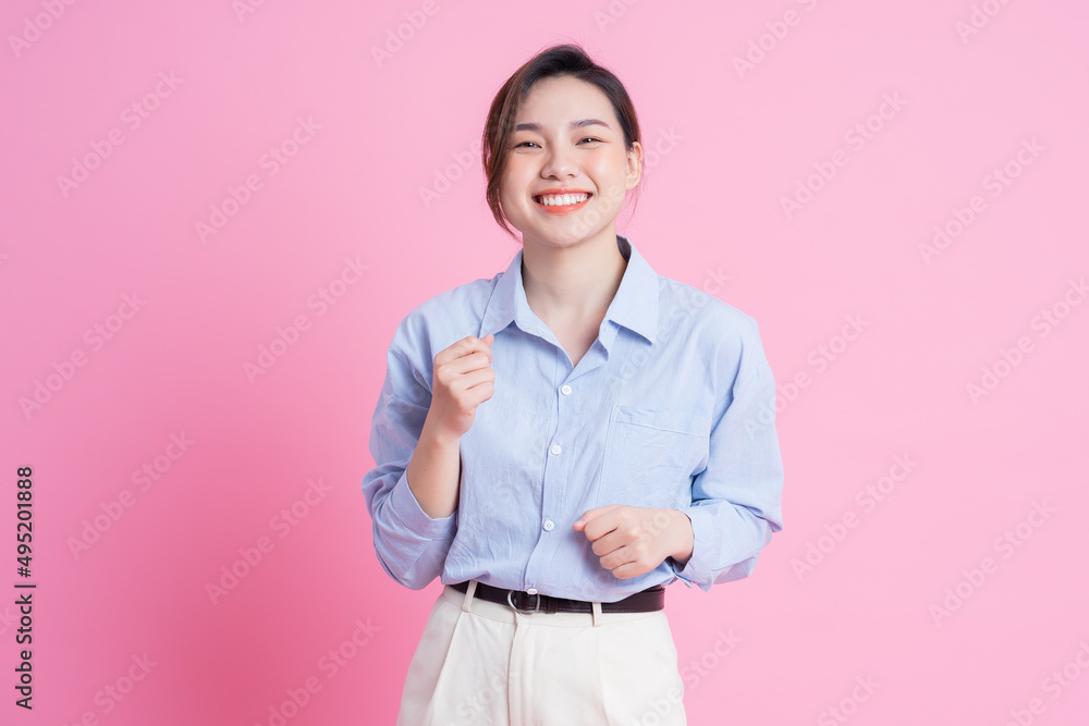 Image of young beautiful Asian girl posing on pink background Image of young beautiful Asian girl posing on pink background