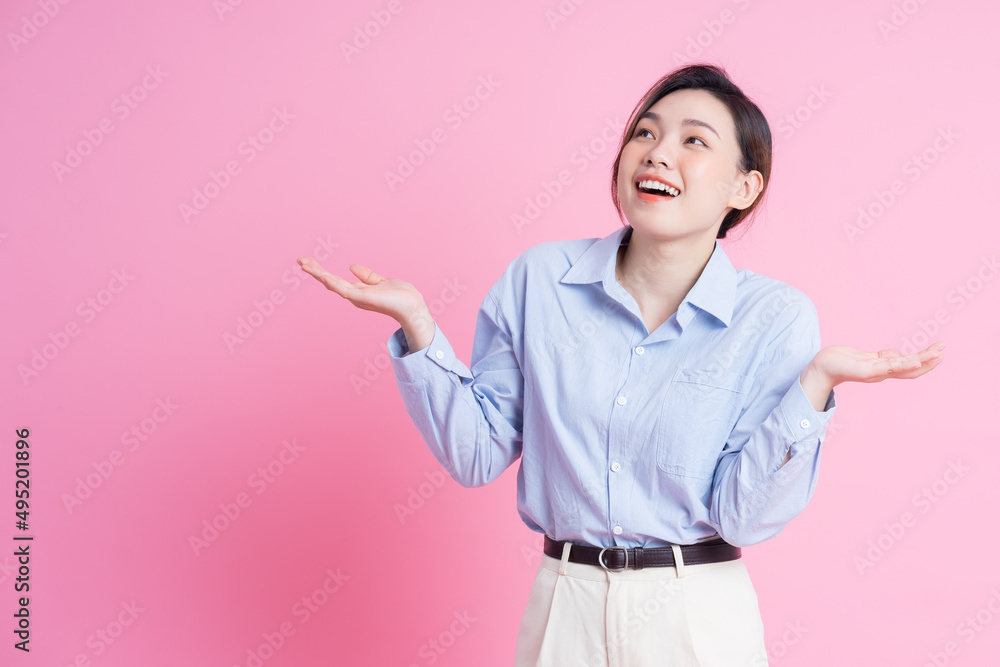 Image of young beautiful Asian girl posing on pink background Image of young beautiful Asian girl posing on pink background