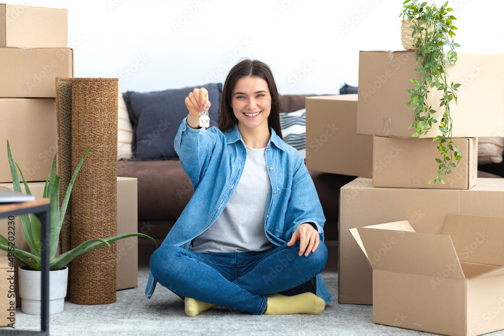 Moving to a new house, rental housing. Happy young caucasian woman ...