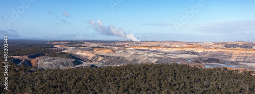 panoramic image of open cut coal mine and power station in distance photo