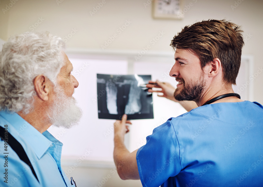 You see theres nothing to worry about. Shot of a young doctor and his senior patient looking at an x-ray together. You see theres nothing to worry about. Shot of a young doctor and his senior patient looking at an x-ray together.