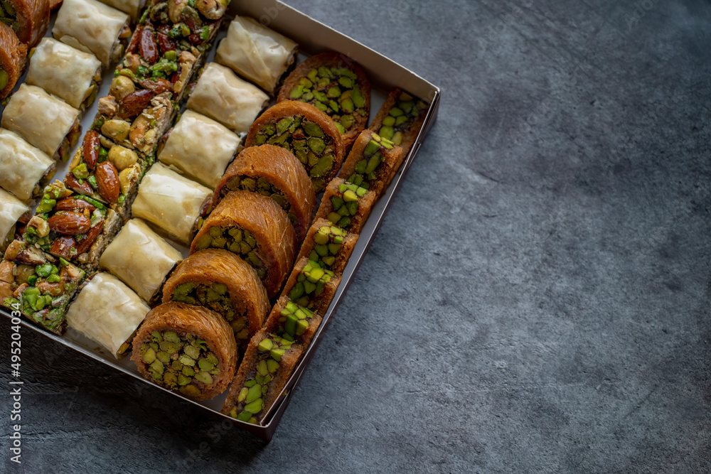 Arabic and Turkish oriental sweets Desserts made of pistachios and kunafa with leafy dough - obrazy, fototapety, plakaty 