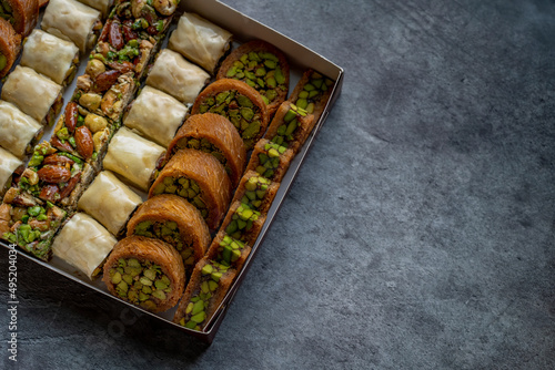 Arabic and Turkish oriental sweets Desserts made of pistachios and kunafa with leafy dough photo