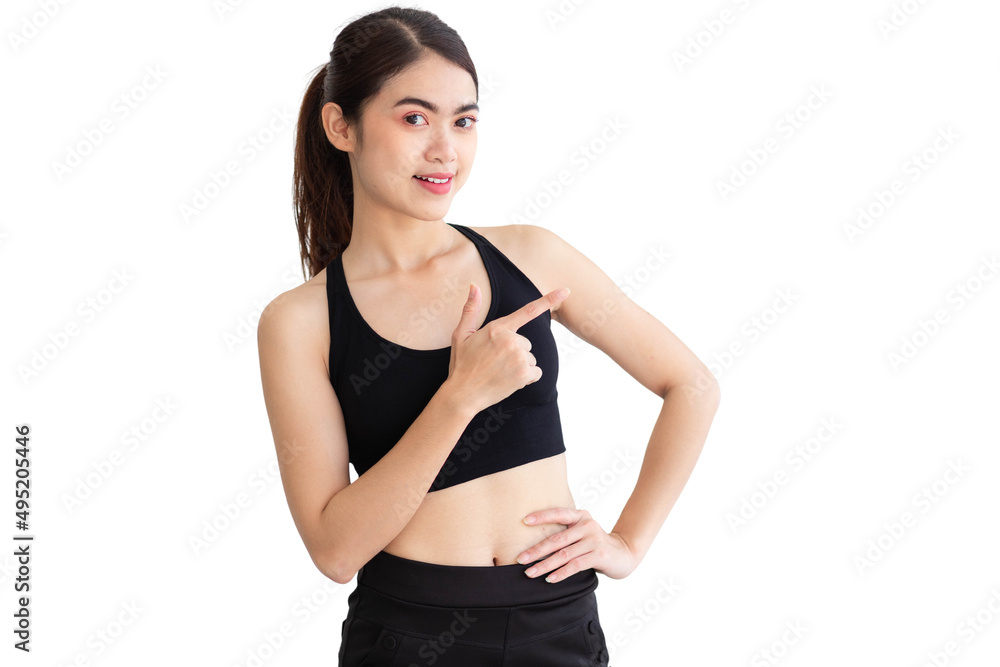 A Thai Southeast Asian woman wearing a black workout clothes is smiling and pointing up. isolated on a white background A Thai Southeast Asian woman wearing a black workout clothes is smiling and pointing up. isolated on a white background