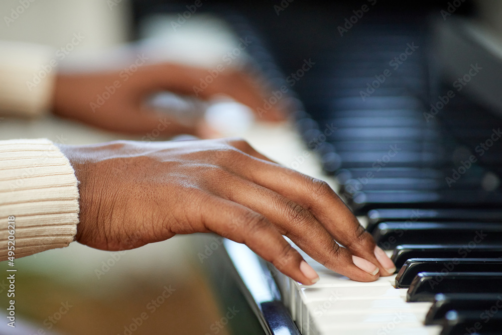 Obraz premium Close-up of female hands playing the piano during musical lesson