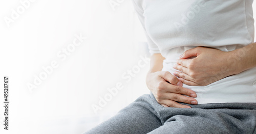Quadro su tela Young woman put her hand on her stomach because she had a very bad stomachache