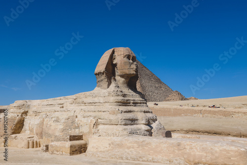 Main View to the Great Sphinx of Giza, is a giant limestone statue with the Great Pyramid in Background in Giza, Egypt