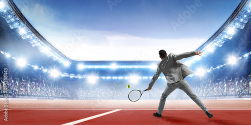 Businessman playing tennis . Mixed media