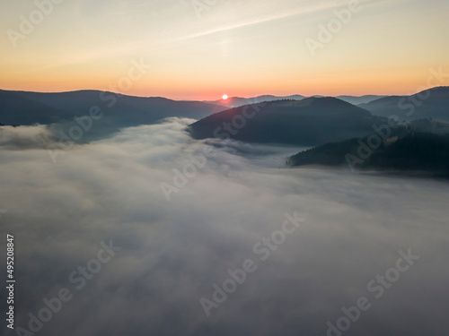 Sunrise over the fog in the Ukrainian Carpathians. Aerial drone view.