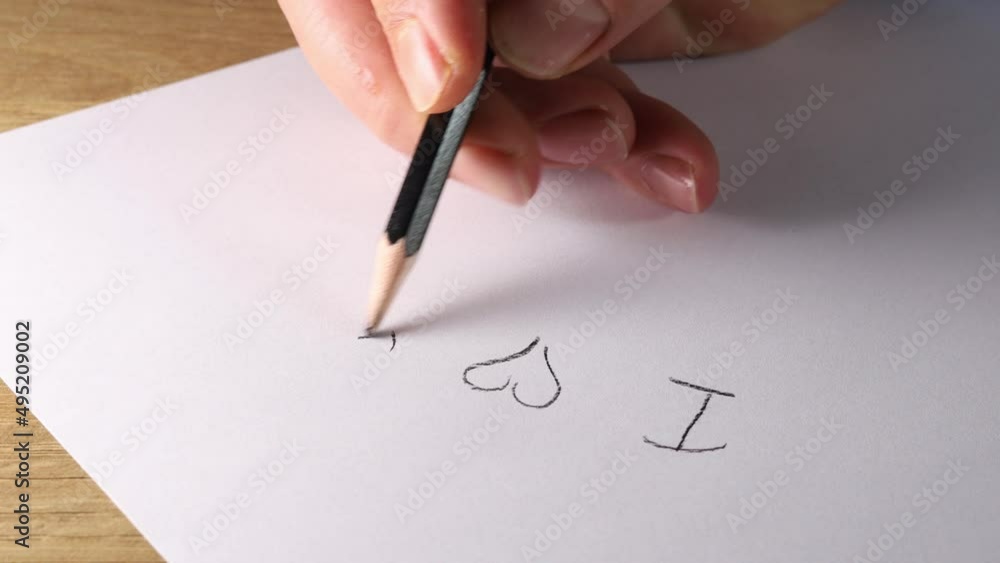 close-up hand with pen. I love you word. Love theme.
close-up hand with pen. I love you word. Love theme.
