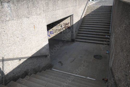 Stairs down to a pedestrian subway, with graffiti 