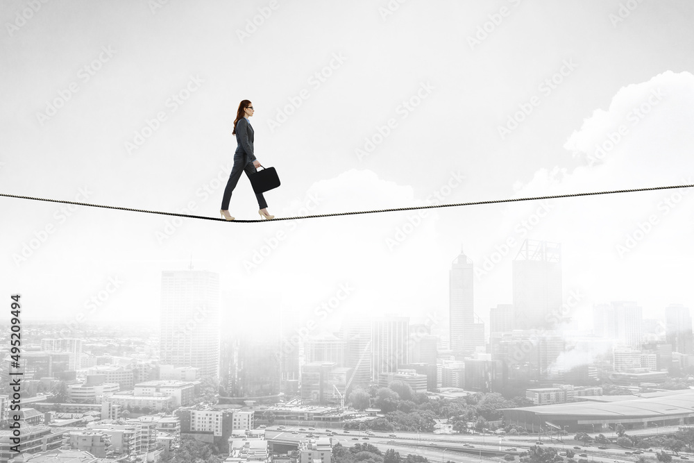 Image of businesswoman balancing on rope. Risk concept Image of businesswoman balancing on rope. Risk concept