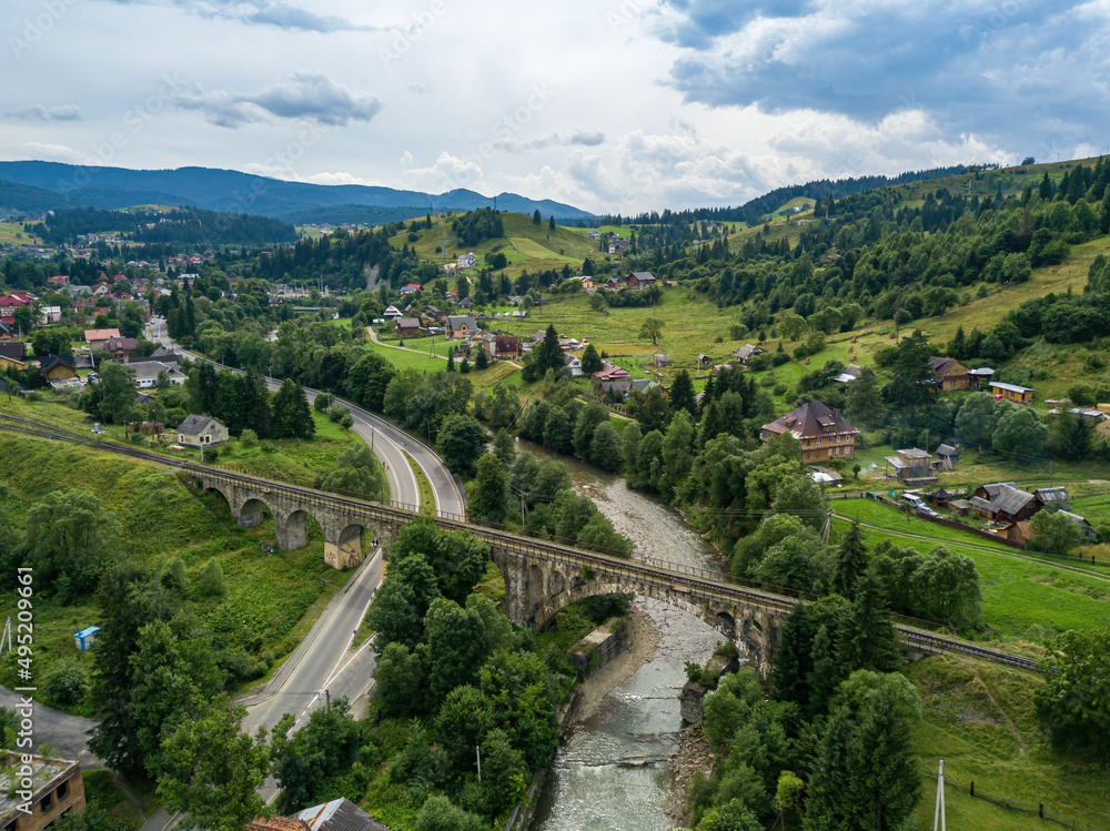 Old railway bridge in the mountains. Ukrainian Carpathians. Aerial drone view. Old railway bridge in the mountains. Ukrainian Carpathians. Aerial drone view.