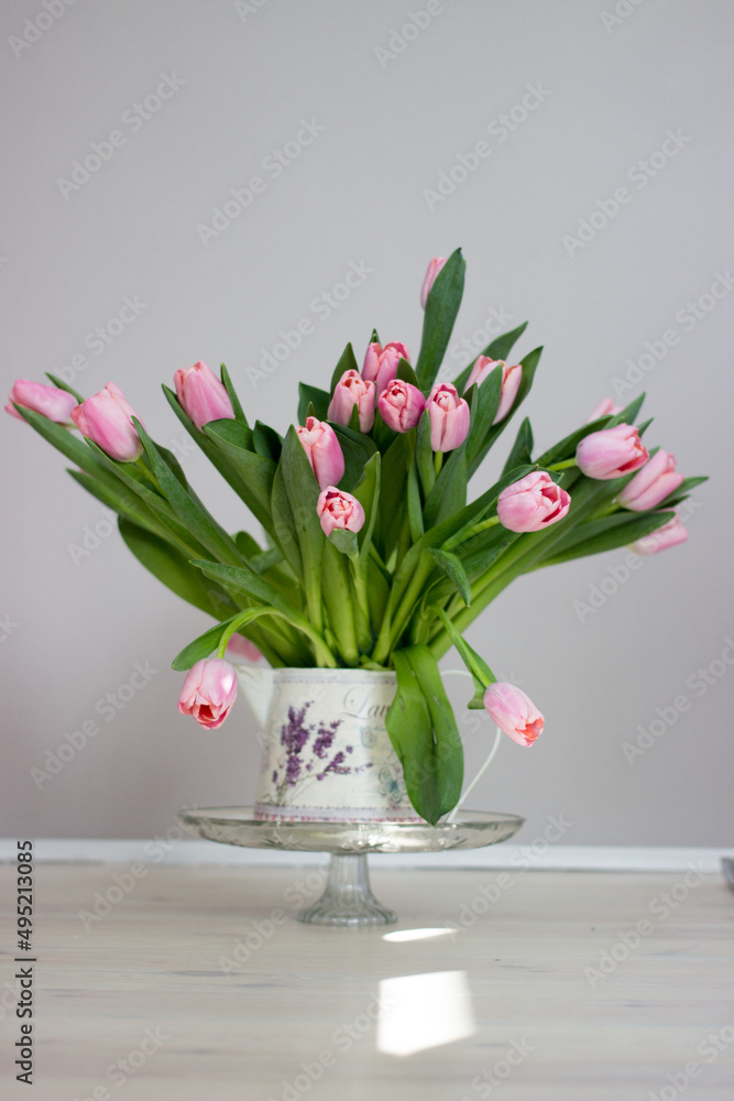 Fresh pink tulip flowers bouquet on shelf in front of stone wall. View with copy space Fresh pink tulip flowers bouquet on shelf in front of stone wall. View with copy space