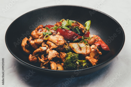 Close up shot of a bowl of stir fried meat and vegetables
