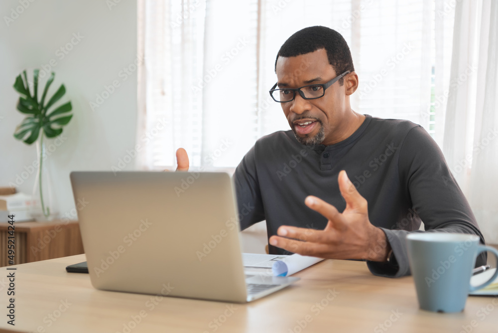 African American man having video call with a laptop at home. African American man having video call with a laptop at home.