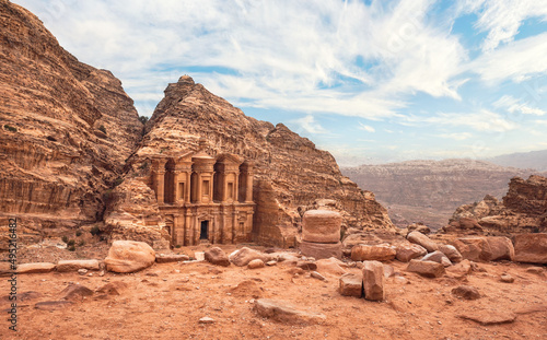 Ad Deir - Monastery - ruins carved in rocky wall at Petra Jordan, mountainous terrain background