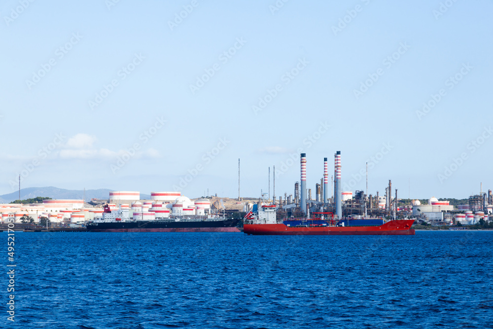 Oil ship docked at the oil berth in oil refinery.