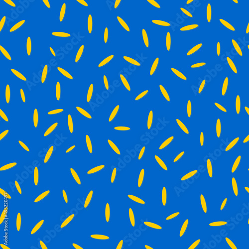 Seamless modern pattern with elements of yellow rice grains on a blue background. Printing on fashion fabrics, textiles, decorative pillows, wrapping paper. 
