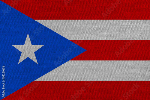 Patriotic textile background in colors of national flag. Puerto Rico
