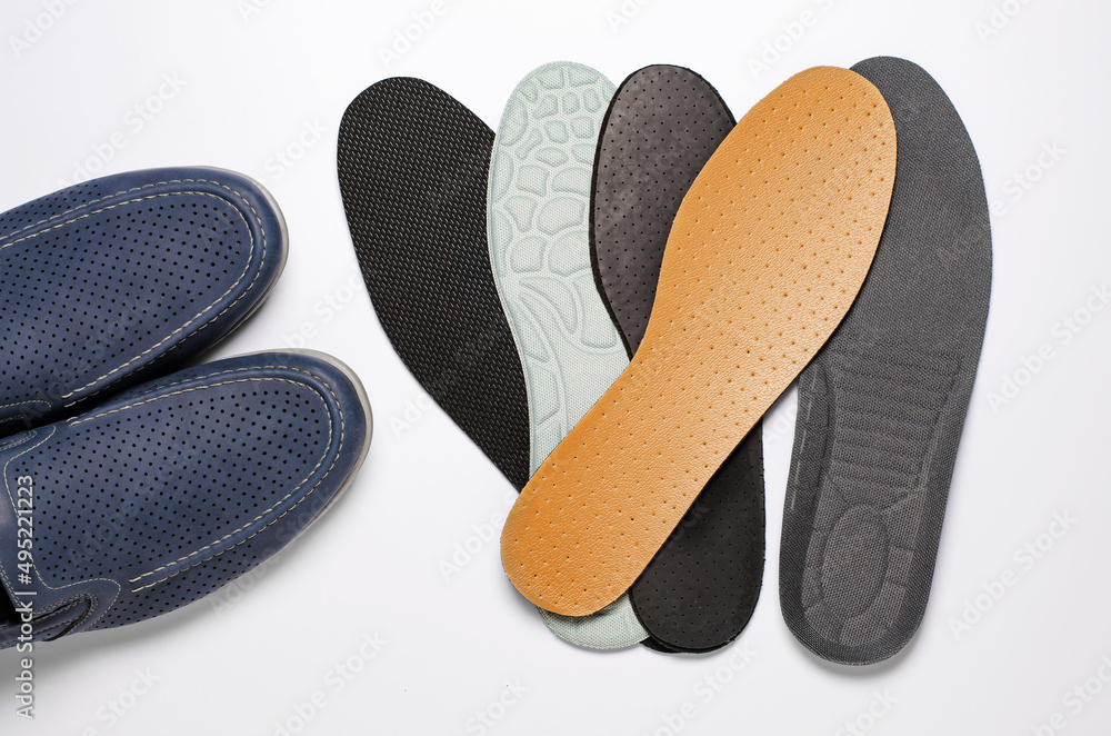 Different insoles for shoes. White background. Close up Different insoles for shoes. White background. Close up