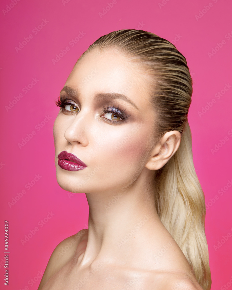 Fototapeta premium Closeup front portrait of young woman with makeup, hair straightened, isolated purple background.