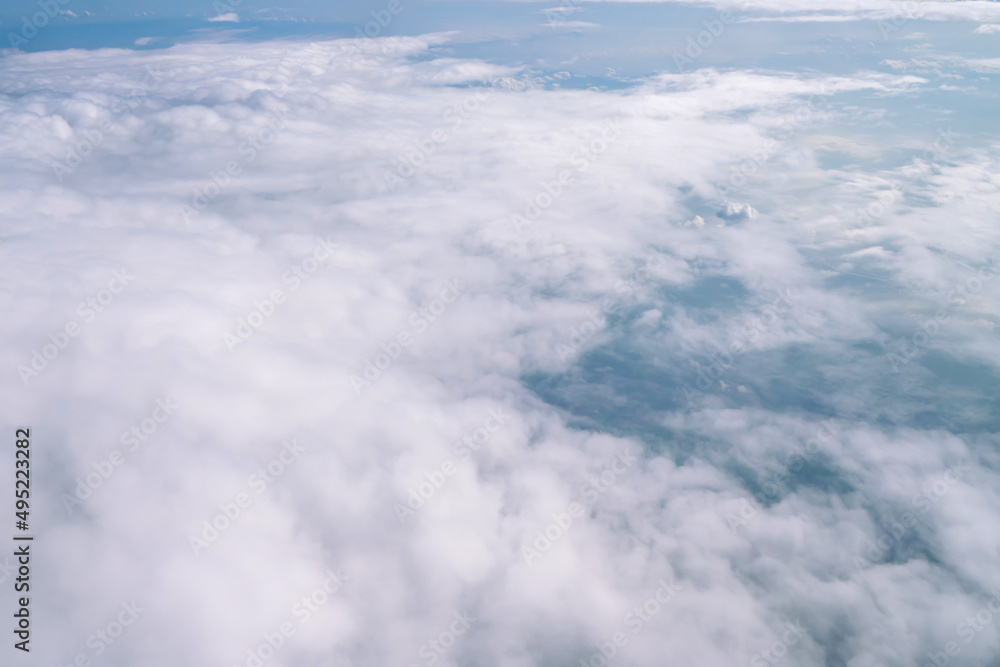 Naklejka premium Blue sky and Clouds as seen through window of aircraft